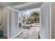 Inviting outdoor patio space with comfortable seating and a view of the lush landscaping, perfect for relaxation at 121 Holly Ave, Sarasota, FL 34243