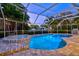 Backyard pool and spa enclosed in a screened lanai, offering a private oasis for relaxation and recreation at 121 Holly Ave, Sarasota, FL 34243