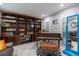 Reading nook with a built-in bookcase, piano, and comfortable seating at 121 Holly Ave, Sarasota, FL 34243