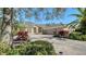 Beautifully landscaped home with a stone-accented facade and a well-manicured lawn, exuding elegance and charm at 12471 Natureview Cir, Bradenton, FL 34212