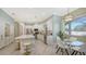Bright kitchen features an island with seating and a casual dining space overlooking the backyard at 12471 Natureview Cir, Bradenton, FL 34212