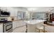 Well-lit kitchen featuring stainless steel appliances, granite countertops, and a breakfast bar, perfect for modern cooking at 12471 Natureview Cir, Bradenton, FL 34212