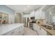 Bright kitchen has stainless steel appliances, granite counters, an island, and white cabinets at 12471 Natureview Cir, Bradenton, FL 34212