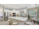 Bright kitchen features an island with seating, stainless steel appliances, and natural light from the adjacent breakfast nook at 12471 Natureview Cir, Bradenton, FL 34212