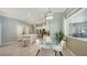 Bright kitchen with an eating area featuring white cabinetry, stainless steel appliances, and a modern pendant light at 12471 Natureview Cir, Bradenton, FL 34212