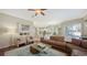 Spacious living room with hardwood floors has access to the kitchen and outdoor living areas at 12471 Natureview Cir, Bradenton, FL 34212