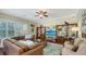 Spacious living room features hardwood floors, built-in bookshelves, and plantation shutters at 12471 Natureview Cir, Bradenton, FL 34212