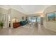 Comfortable living room with natural light, views of the pool area, and a seamless connection to the outdoors at 12471 Natureview Cir, Bradenton, FL 34212
