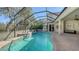 Screened-in pool area featuring a custom pool with calming water features and a comfortable seating area at 12471 Natureview Cir, Bradenton, FL 34212