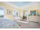 Bright bedroom with water views, balcony access, and a seating area at 12917 42Nd W Ter, Cortez, FL 34215