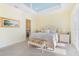 Cozy bedroom features floral bedding, a striped bench, and light yellow walls at 12917 42Nd W Ter, Cortez, FL 34215