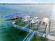 Boat dock featuring boat slips with lifts and canopies in a waterfront setting near a bridge at 12917 42Nd W Ter, Cortez, FL 34215
