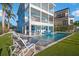An elevated exterior view of the home shows the pool, patio, and a spacious yard at 12917 42Nd W Ter, Cortez, FL 34215