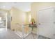 Well-lit hallway featuring a staircase, neutral tones, and decorative accents at 12917 42Nd W Ter, Cortez, FL 34215