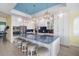Bright kitchen with a large island, seating, stainless steel appliances, and blue backsplash at 12917 42Nd W Ter, Cortez, FL 34215