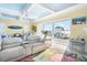 Inviting living room with water views, a ceiling fan, and comfortable white seating at 12917 42Nd W Ter, Cortez, FL 34215