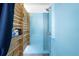 An outdoor shower shows wood accents and blue walls, providing both privacy and modern functionality at 12917 42Nd W Ter, Cortez, FL 34215