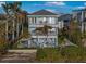 Charming three-story home featuring balconies, a backyard pool, and lush landscaping at 12917 42Nd W Ter, Cortez, FL 34215