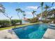 The swimming pool provides waterfront views and landscaping with green grass and palms at 12917 42Nd W Ter, Cortez, FL 34215