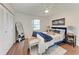 Bedroom with hardwood floors, a closet with sliding doors, and a bed with a blue bedspread at 20032 Sancraft Ave, Port Charlotte, FL 33954