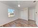 A bright bedroom featuring wood-look flooring, ceiling fan and closet at 20032 Sancraft Ave, Port Charlotte, FL 33954