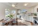 Bright eat-in kitchen with stainless steel appliances, white cabinets, and a large window at 20032 Sancraft Ave, Port Charlotte, FL 33954