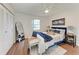 This main bedroom features ample natural light, a ceiling fan, and wood floors at 20032 Sancraft Ave, Port Charlotte, FL 33954