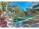 Community shuffleboard courts amidst palm trees with benches and seating for outdoor enjoyment and recreation at 20032 Sancraft Ave, Port Charlotte, FL 33954