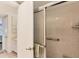 Bright bathroom featuring a tiled shower and vanity with storage at 4350 Chatham Dr # E106, Longboat Key, FL 34228