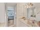 Bathroom features a white vanity with ample storage and an open view to the bedroom at 4350 Chatham Dr # E106, Longboat Key, FL 34228