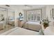 Cozy bedroom featuring mirrored closet doors and twin beds near a bright window at 4350 Chatham Dr # E106, Longboat Key, FL 34228