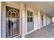 Entrance featuring a secure screen door and neutral tones, offering a glimpse of the interior at 4350 Chatham Dr # E106, Longboat Key, FL 34228