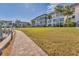 Exterior view of condos with a landscaped lawn and walkway at 4350 Chatham Dr # E106, Longboat Key, FL 34228