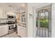 Compact kitchen featuring stainless steel appliances, granite countertops, and ample cabinet space at 4350 Chatham Dr # E106, Longboat Key, FL 34228