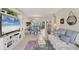 Open-concept living room with water view, offering a seamless flow for relaxation and entertaining at 4350 Chatham Dr # E106, Longboat Key, FL 34228