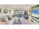 Serene living room with waterfront view, a plush sofa, and a stylish entertainment center at 4350 Chatham Dr # E106, Longboat Key, FL 34228