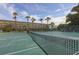 Outdoor tennis court with pristine green surface and meticulously maintained net at 4350 Chatham Dr # E106, Longboat Key, FL 34228