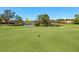 Scenic view of the golf course with a pond and sand traps on a sunny day, with manicured green grass at 5259 Everwood Run, Sarasota, FL 34235