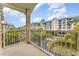Balcony view with tropical trees of condominium complex on a sunny day at 559 Bahia Beach Blvd, Ruskin, FL 33570