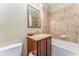 Bathroom featuring a wooden vanity, tiled floor, and shower tub combo at 559 Bahia Beach Blvd, Ruskin, FL 33570