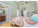 Bedroom with a ceiling fan, wood floors, and ensuite bathroom access at 559 Bahia Beach Blvd, Ruskin, FL 33570