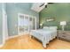 Comfortable bedroom with high ceilings, shuttered windows, and hardwood floors at 559 Bahia Beach Blvd, Ruskin, FL 33570