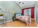 Cozy bedroom with a large window, light wood floors and neutral decor at 559 Bahia Beach Blvd, Ruskin, FL 33570