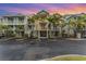Multi-Gathering home with covered parking and tropical landscaping at dusk at 559 Bahia Beach Blvd, Ruskin, FL 33570