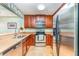 Kitchen with stainless steel appliances, granite countertops, and wood cabinets at 559 Bahia Beach Blvd, Ruskin, FL 33570