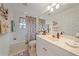 This bathroom boasts a shower-tub combination, a large vanity, and coordinated décor at 6334 Grand Oak Cir # 201, Bradenton, FL 34203