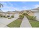 The exterior showcases a well-maintained lawn, manicured landscaping, and an attached single-car garage at 6334 Grand Oak Cir # 201, Bradenton, FL 34203