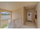 A welcoming entrance features a door with a wreath and a view of the staircase at 6334 Grand Oak Cir # 201, Bradenton, FL 34203