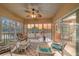 Enclosed lanai with comfortable seating, ceiling fan, and sunset views over the water at 6334 Grand Oak Cir # 201, Bradenton, FL 34203