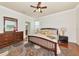 Spacious bedroom featuring wood floors, ensuite bath, walk-in closet and ample natural light at 6814 Willowshire Way, Bradenton, FL 34212